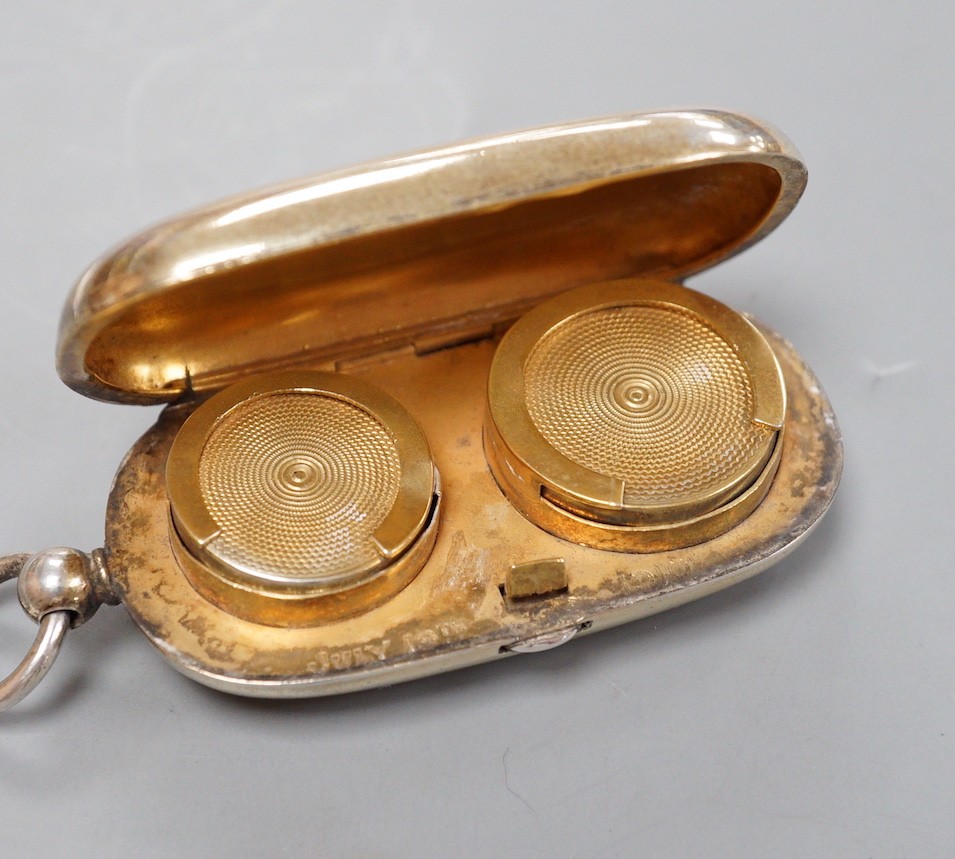 A George V silver silver gilt oval sovereign/half sovereign case, with engraved initials, Goldsmiths & Silversmiths Co Ltd, London, 1910 (gilding worn), 66mm.